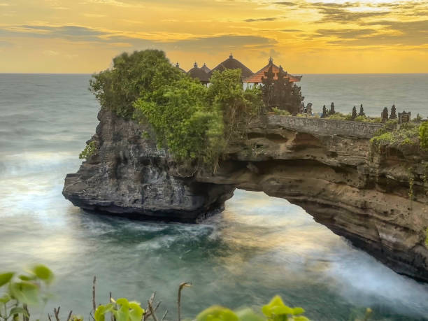 tanah lot temple on sea in bali island indonesia, long exposure.